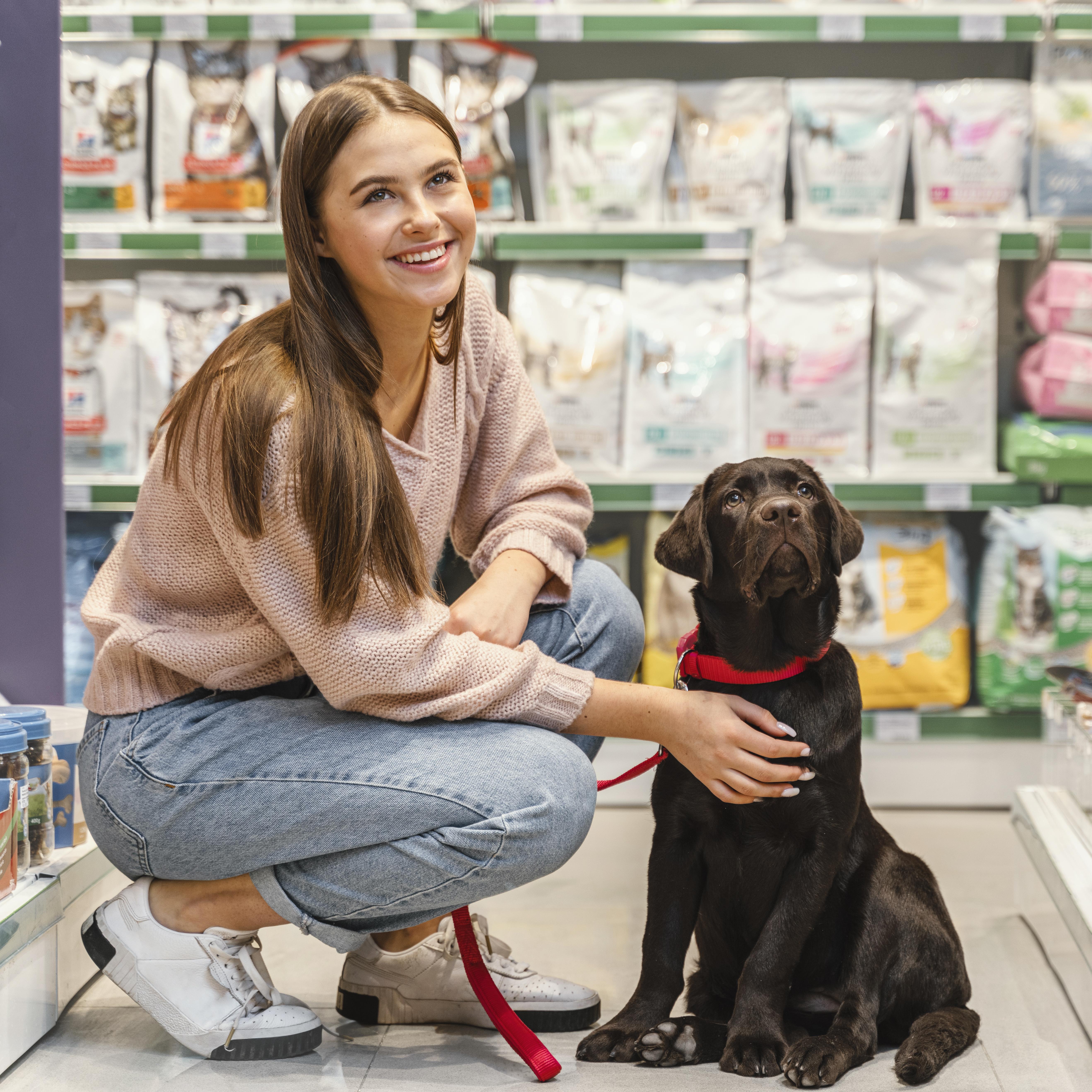 adorable-dog-with-female-owner-pet-shop
